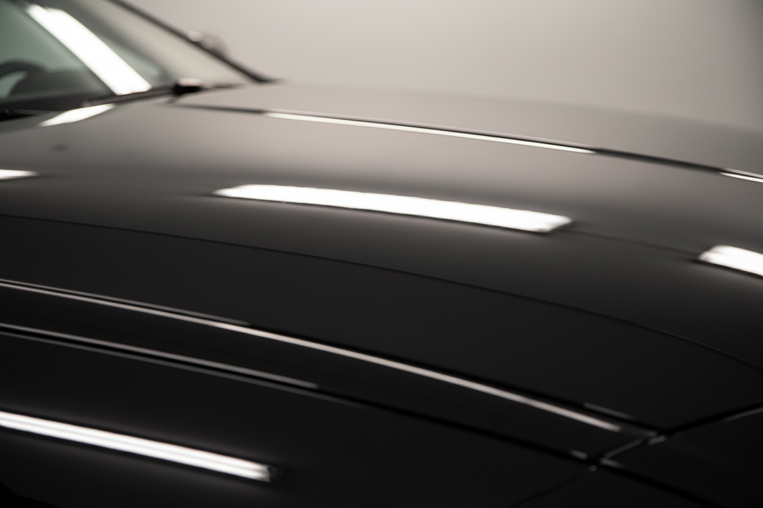 Deep mirror reflection across a ceramic-coated fender showing a flawless even high-gloss finish