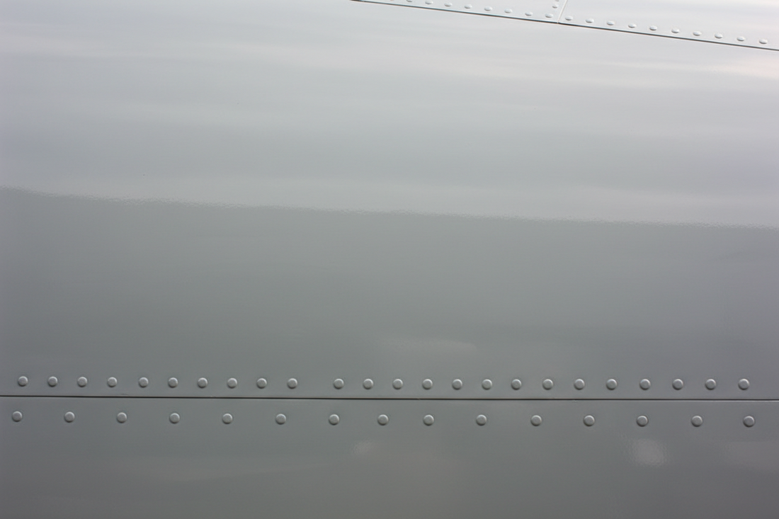 Pristine repaired fuselage skin with a seamlessly blended coating and no visible repair edge