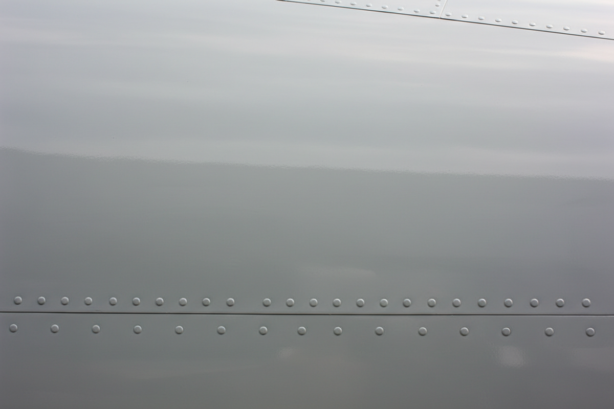 Pristine repaired fuselage skin with a seamlessly blended coating and no visible repair edge